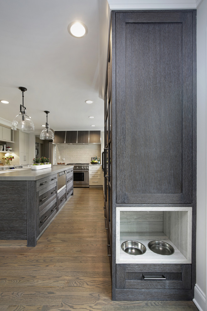 Example of a large minimalist u-shaped light wood floor open concept kitchen design in Chicago with an undermount sink, recessed-panel cabinets, white cabinets, quartzite countertops, white backsplash, cement tile backsplash, stainless steel appliances, an island and white countertops