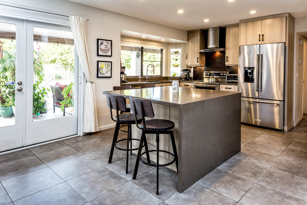 Large urban l-shaped kitchen/diner in Phoenix with a built-in sink, flat-panel cabinets, light wood cabinets, concrete worktops, brown splashback, stainless steel appliances, ceramic flooring, an island and grey floors.