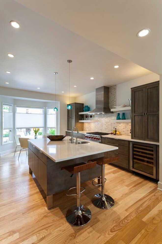 Large minimalist galley light wood floor open concept kitchen photo in Philadelphia with a drop-in sink, shaker cabinets, gray cabinets, multicolored backsplash, stainless steel appliances and an island