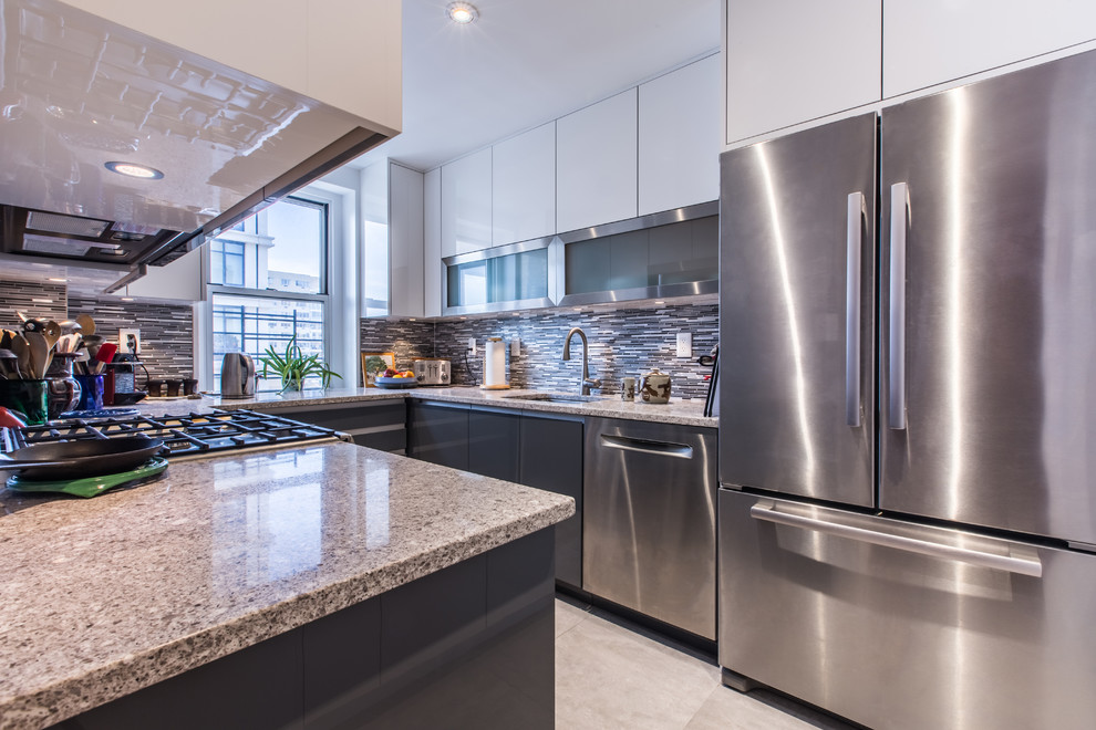 Inspiration for a small modern u-shaped ceramic tile enclosed kitchen remodel in New York with an undermount sink, flat-panel cabinets, gray cabinets, granite countertops, gray backsplash, matchstick tile backsplash, stainless steel appliances and no island