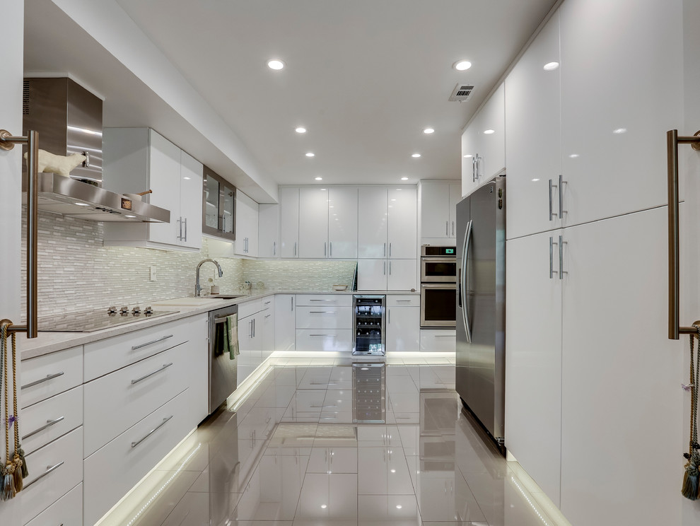 Inspiration for a modern kitchen in DC Metro with a submerged sink, flat-panel cabinets, engineered stone countertops, glass tiled splashback and stainless steel appliances.