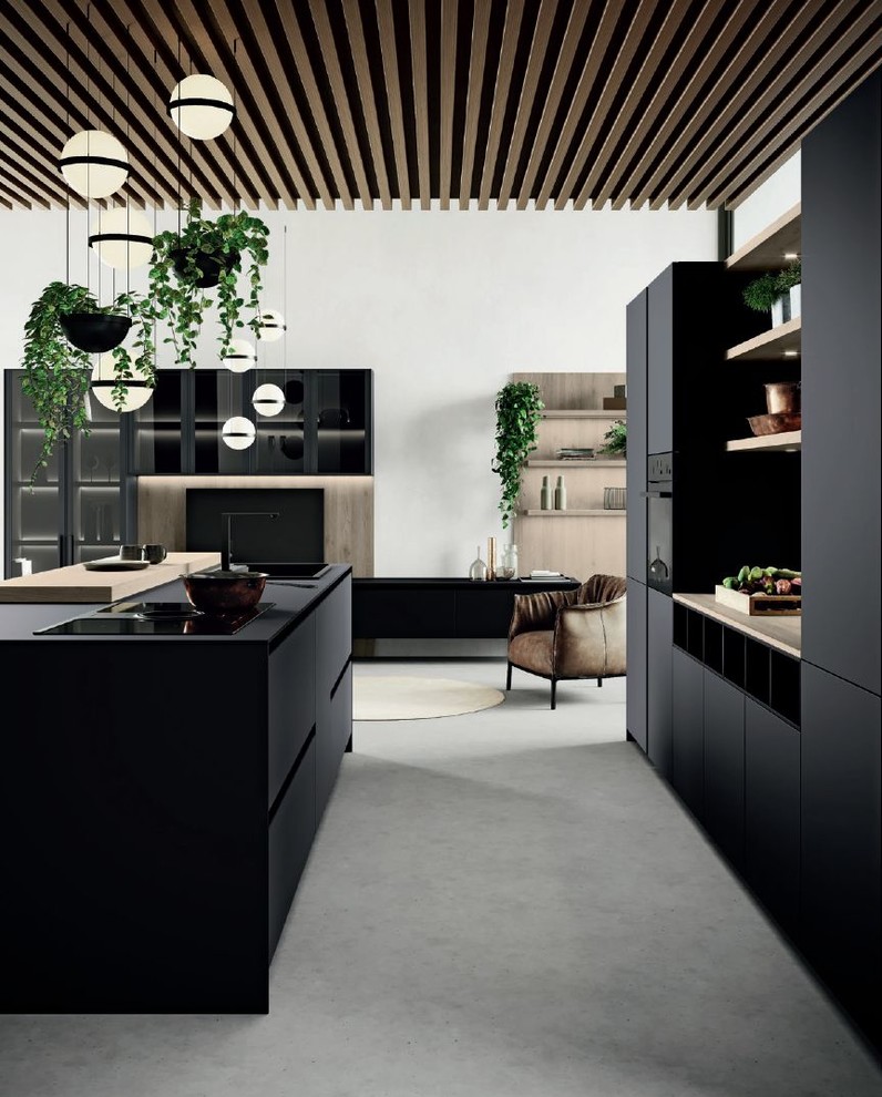 Inspiration for a medium sized modern galley open plan kitchen in San Francisco with a built-in sink, flat-panel cabinets, black cabinets, wood worktops, black appliances, concrete flooring, an island, grey floors and brown worktops.