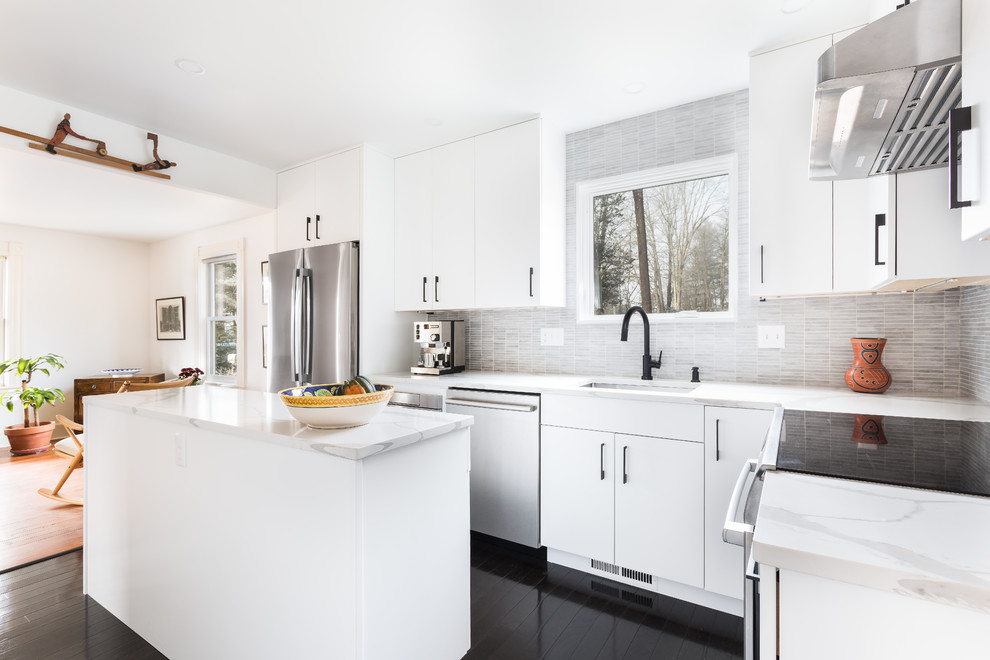 Inspiration for a mid-sized modern l-shaped painted wood floor and black floor enclosed kitchen remodel in Boston with an undermount sink, flat-panel cabinets, white cabinets, quartzite countertops, gray backsplash, porcelain backsplash, stainless steel appliances, an island and yellow countertops