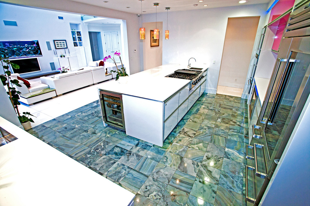 Photo of a medium sized modern enclosed kitchen in Los Angeles with a submerged sink, flat-panel cabinets, white cabinets, engineered stone countertops, stainless steel appliances, marble flooring, an island and green floors.