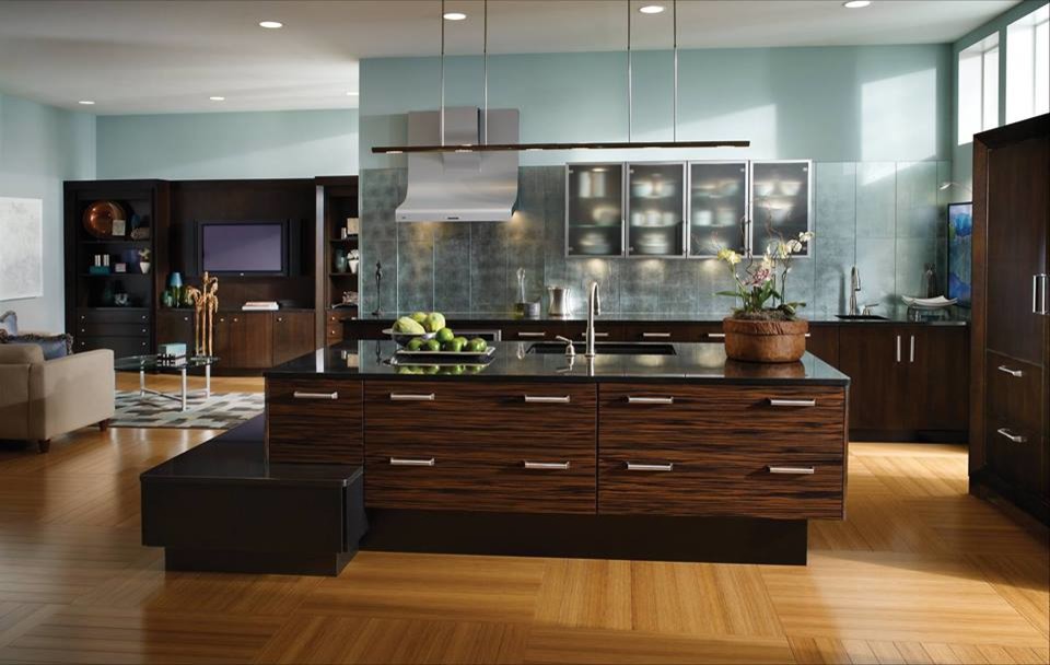Inspiration for a large contemporary l-shaped open plan kitchen in Houston with an integrated sink, flat-panel cabinets, dark wood cabinets, composite countertops, blue splashback, metal splashback, stainless steel appliances, an island and light hardwood flooring.
