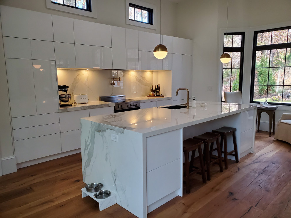 Example of a large minimalist single-wall light wood floor open concept kitchen design in Other with a single-bowl sink, flat-panel cabinets, white cabinets, porcelain backsplash, stainless steel appliances, an island and tile countertops