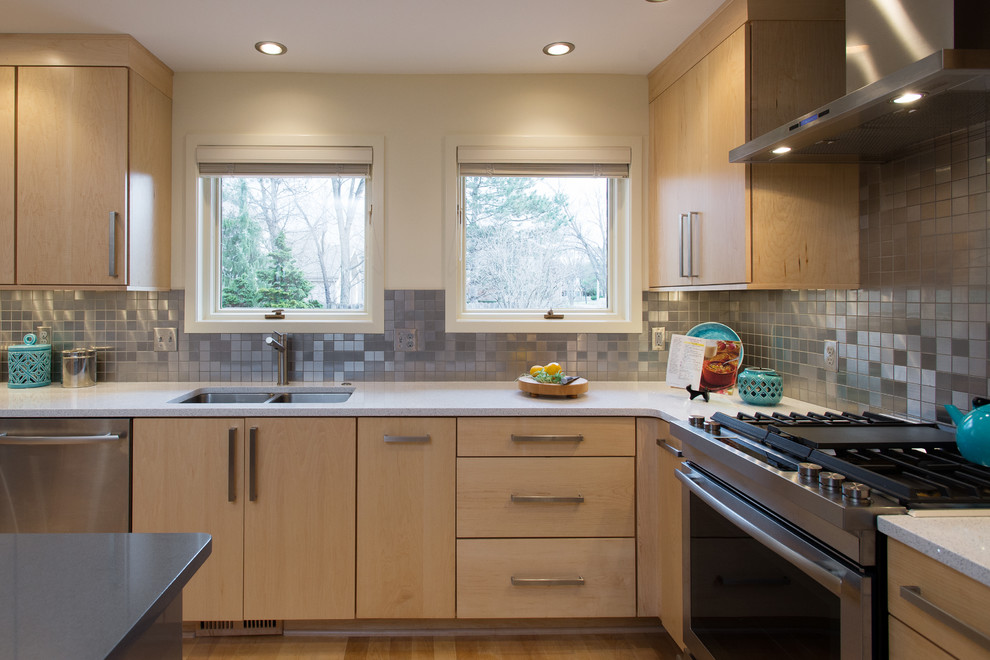 Large transitional u-shaped eat-in kitchen photo in Other with flat-panel cabinets, light wood cabinets, quartzite countertops, metallic backsplash and an island