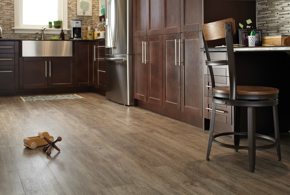 Eat-in kitchen - modern galley medium tone wood floor eat-in kitchen idea in Toronto with beaded inset cabinets, medium tone wood cabinets, white backsplash and stainless steel appliances