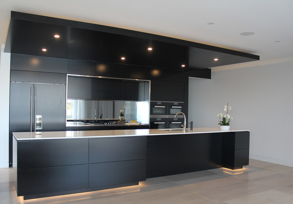 Design ideas for a large contemporary galley open plan kitchen in Sydney with a submerged sink, flat-panel cabinets, black cabinets, marble worktops, mirror splashback, stainless steel appliances, limestone flooring, an island and grey floors.