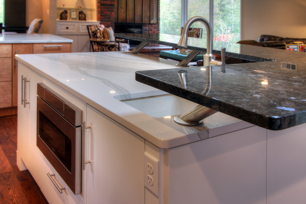 Open concept kitchen - huge modern u-shaped medium tone wood floor open concept kitchen idea in St Louis with an undermount sink, flat-panel cabinets, quartz countertops, white backsplash, porcelain backsplash, stainless steel appliances and an island