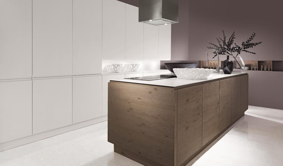 Example of a mid-sized minimalist single-wall porcelain tile eat-in kitchen design in Toronto with an undermount sink, flat-panel cabinets, white cabinets, solid surface countertops, an island and paneled appliances