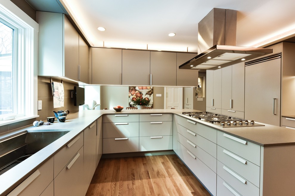 Mid-sized minimalist u-shaped medium tone wood floor eat-in kitchen photo in DC Metro with a farmhouse sink, flat-panel cabinets, gray cabinets, quartz countertops, gray backsplash, porcelain backsplash, paneled appliances and a peninsula
