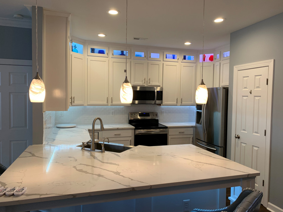Medium sized modern u-shaped kitchen/diner in Charlotte with shaker cabinets, white cabinets, engineered stone countertops and metro tiled splashback.
