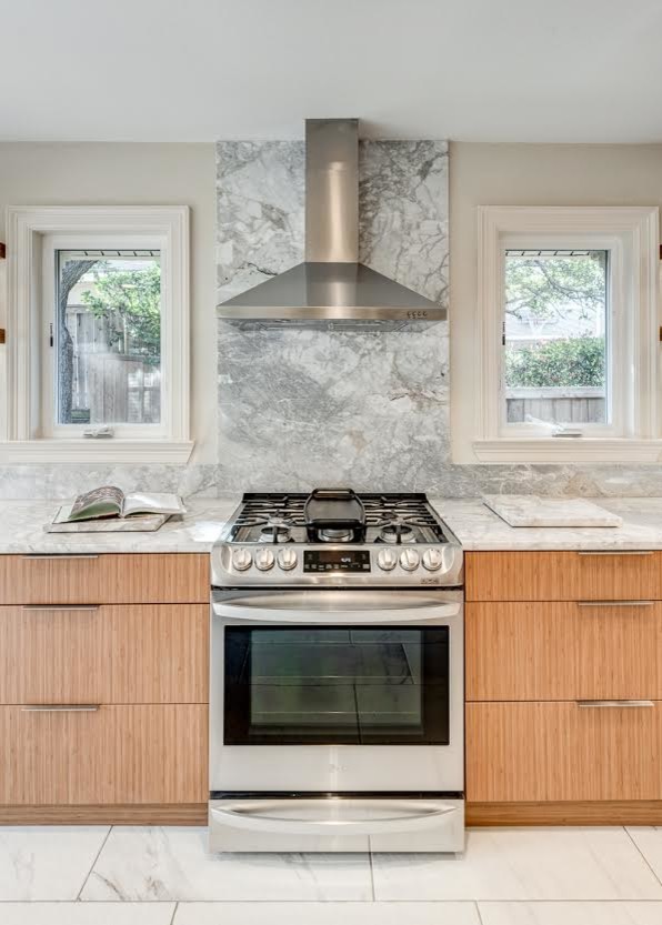 This is an example of a large contemporary l-shaped kitchen/diner in Dallas with a built-in sink, flat-panel cabinets, medium wood cabinets, marble worktops, grey splashback, marble splashback, stainless steel appliances, marble flooring, an island and white floors.