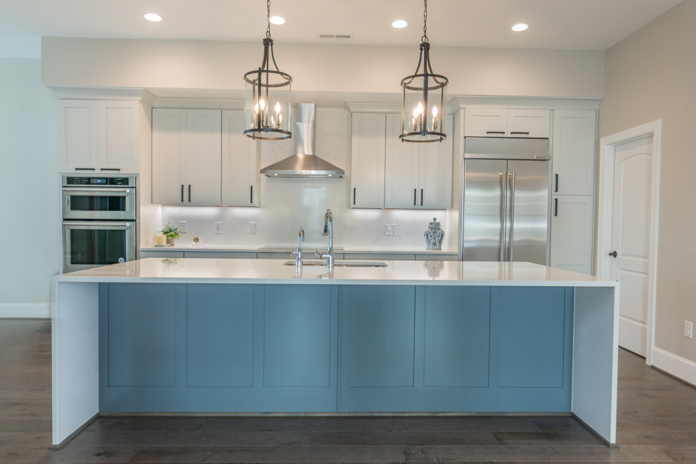 Inspiration for a mid-sized modern galley medium tone wood floor kitchen remodel in DC Metro with an undermount sink, shaker cabinets, quartz countertops, quartz backsplash, stainless steel appliances and an island