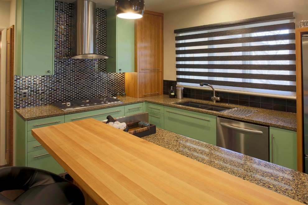 This is an example of a medium sized modern galley enclosed kitchen in Kansas City with a submerged sink, flat-panel cabinets, green cabinets, engineered stone countertops, black splashback, ceramic splashback, stainless steel appliances, dark hardwood flooring and an island.