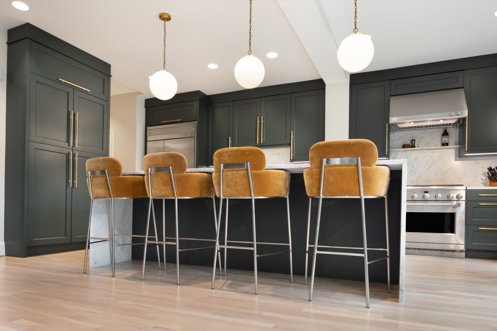 Inspiration for a modern galley light wood floor and brown floor enclosed kitchen remodel in DC Metro with a farmhouse sink, recessed-panel cabinets, green cabinets, quartz countertops, white backsplash, stone slab backsplash, stainless steel appliances, an island and white countertops