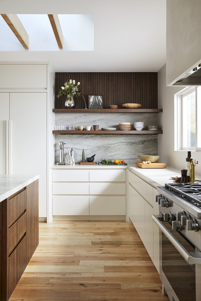 Inspiration för mellanstora moderna grått kök, med en undermonterad diskho, luckor med infälld panel, grå skåp, bänkskiva i kvarts, grått stänkskydd, rostfria vitvaror, ljust trägolv, en köksö och brunt golv