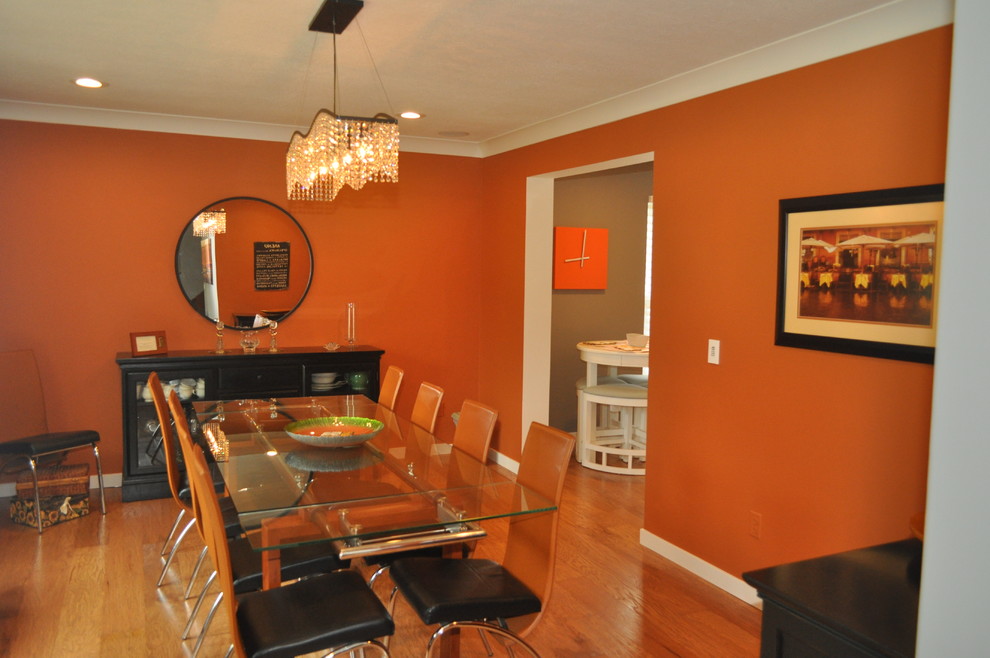 Example of a mid-sized minimalist enclosed dining room design in Tampa with orange walls and no fireplace