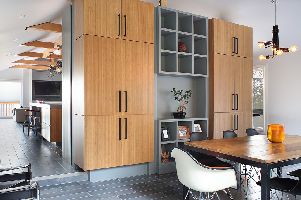 Large contemporary kitchen in New York with an integrated sink, flat-panel cabinets, light wood cabinets, concrete worktops, integrated appliances, cement flooring, multiple islands, grey floors and grey worktops.