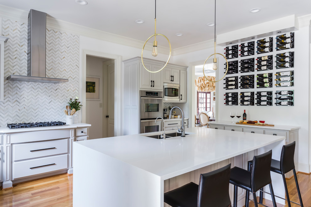 Eat-in kitchen - mid-sized modern u-shaped plywood floor and yellow floor eat-in kitchen idea in Raleigh with an undermount sink, raised-panel cabinets, beige cabinets, quartzite countertops, white backsplash, marble backsplash, stainless steel appliances, an island and white countertops