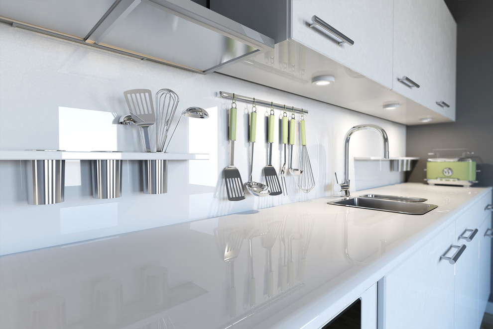 Cette photo montre une petite cuisine linéaire moderne avec des portes de placard blanches, une crédence blanche, une crédence en feuille de verre et un électroménager de couleur.