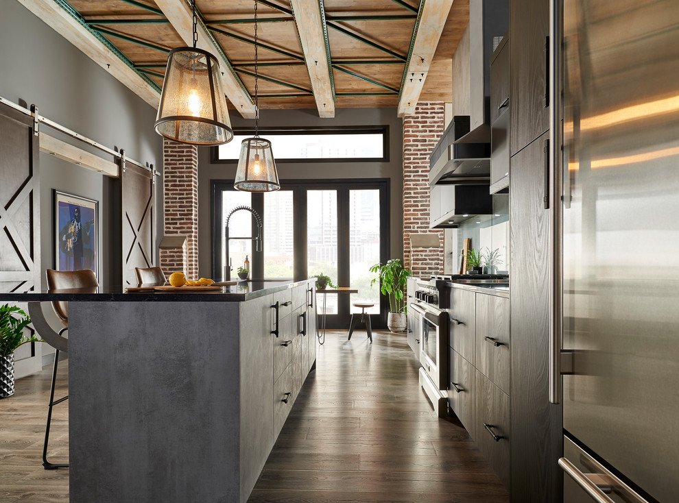 Eat-in kitchen - mid-sized modern single-wall brown floor eat-in kitchen idea in New York with an undermount sink, flat-panel cabinets, black cabinets, solid surface countertops, gray backsplash, glass sheet backsplash, stainless steel appliances, an island and black countertops