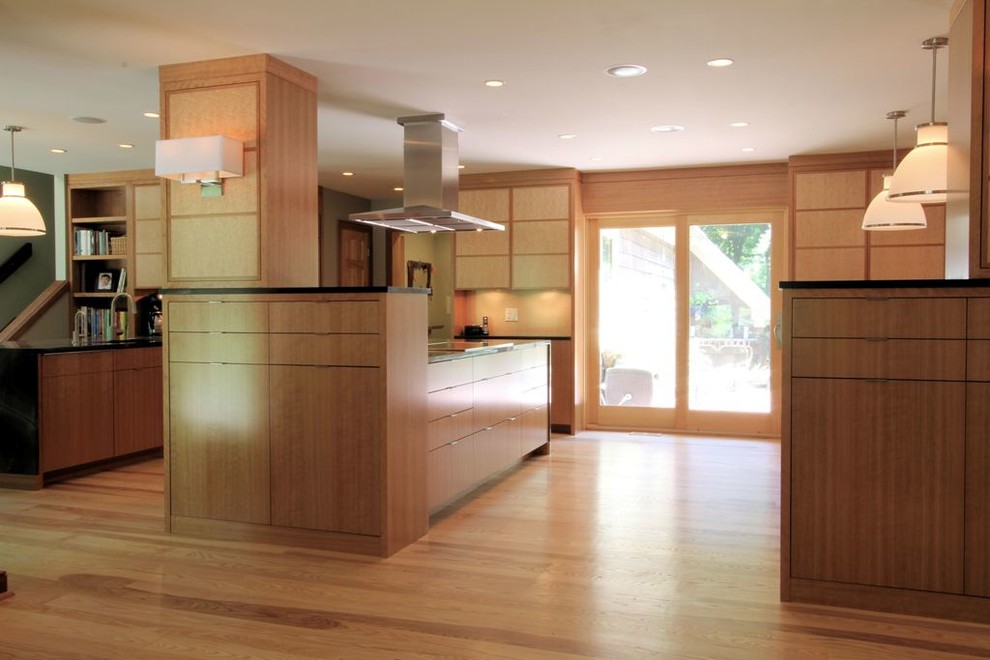 Example of a trendy eat-in kitchen design in Indianapolis with an undermount sink, flat-panel cabinets, medium tone wood cabinets, granite countertops and stainless steel appliances