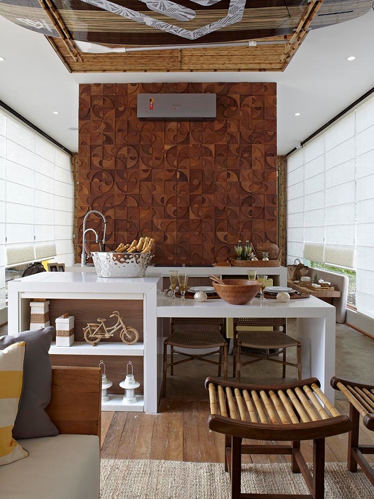 Small minimalist concrete floor eat-in kitchen photo in Miami with an undermount sink, flat-panel cabinets, medium tone wood cabinets, brown backsplash, colored appliances and an island