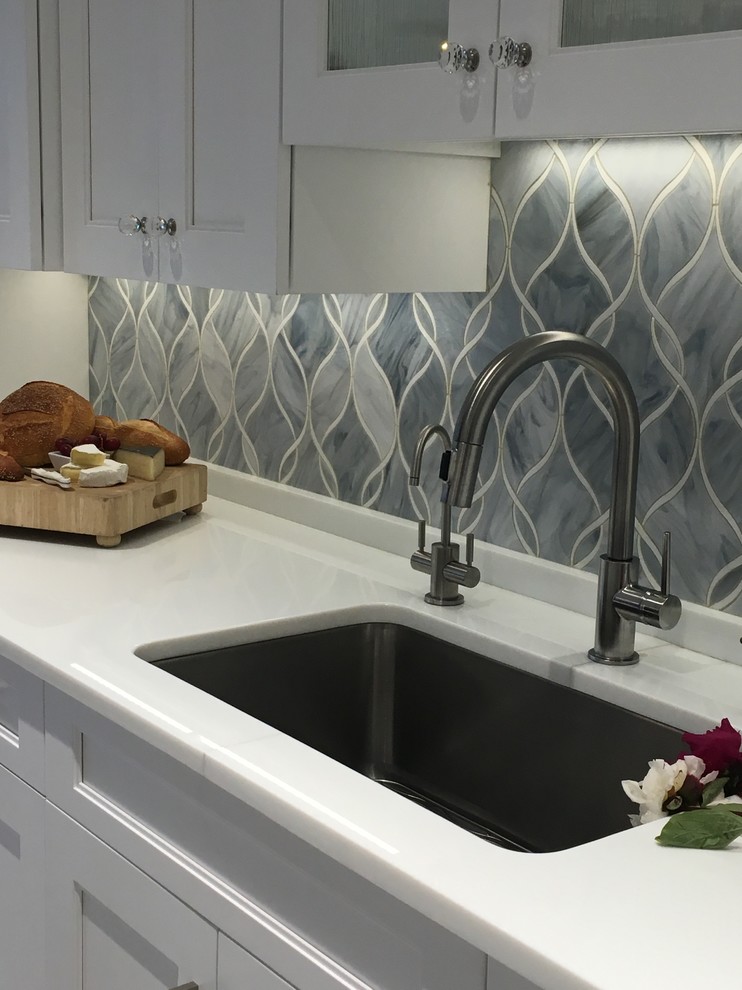 Example of a huge trendy u-shaped ceramic tile eat-in kitchen design in New York with a single-bowl sink, shaker cabinets, white cabinets, quartzite countertops, gray backsplash, glass sheet backsplash, stainless steel appliances and two islands