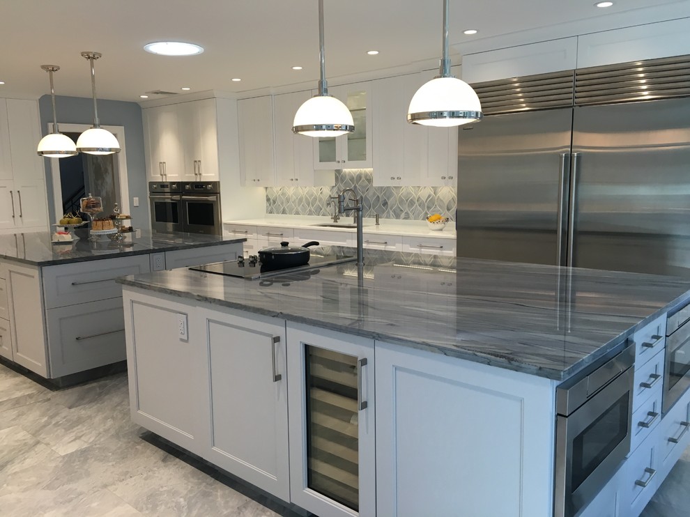 Huge trendy u-shaped ceramic tile eat-in kitchen photo in New York with two islands, shaker cabinets, white cabinets, quartzite countertops, gray backsplash, glass sheet backsplash, stainless steel appliances and a single-bowl sink
