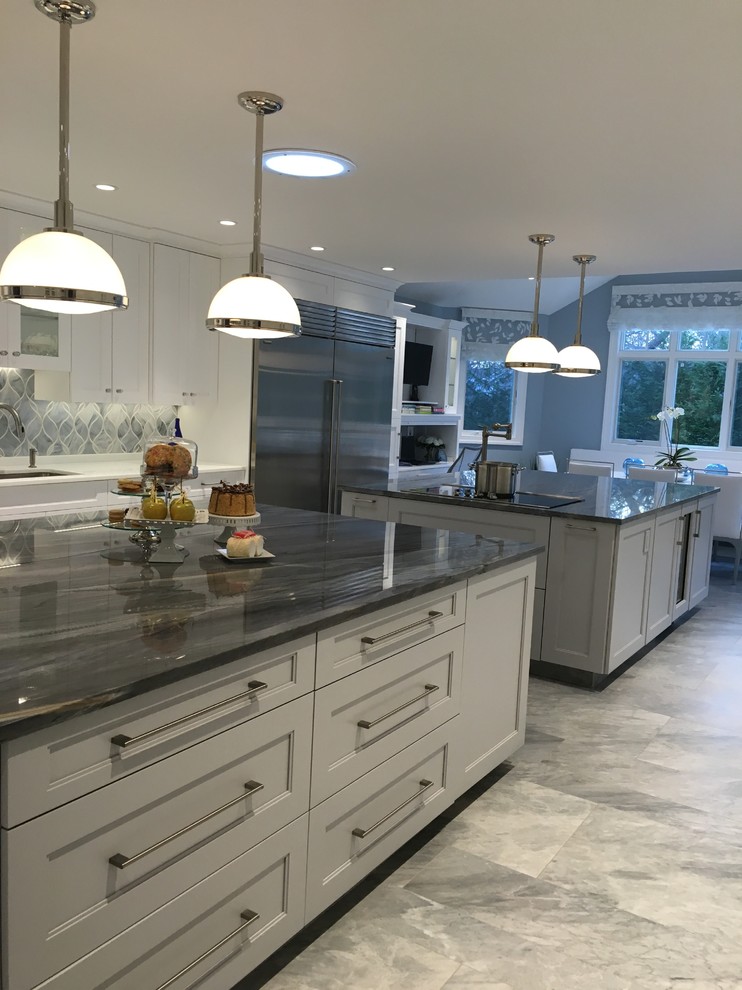 Eat-in kitchen - huge contemporary u-shaped ceramic tile eat-in kitchen idea in New York with a single-bowl sink, shaker cabinets, white cabinets, quartzite countertops, gray backsplash, glass sheet backsplash, stainless steel appliances and two islands