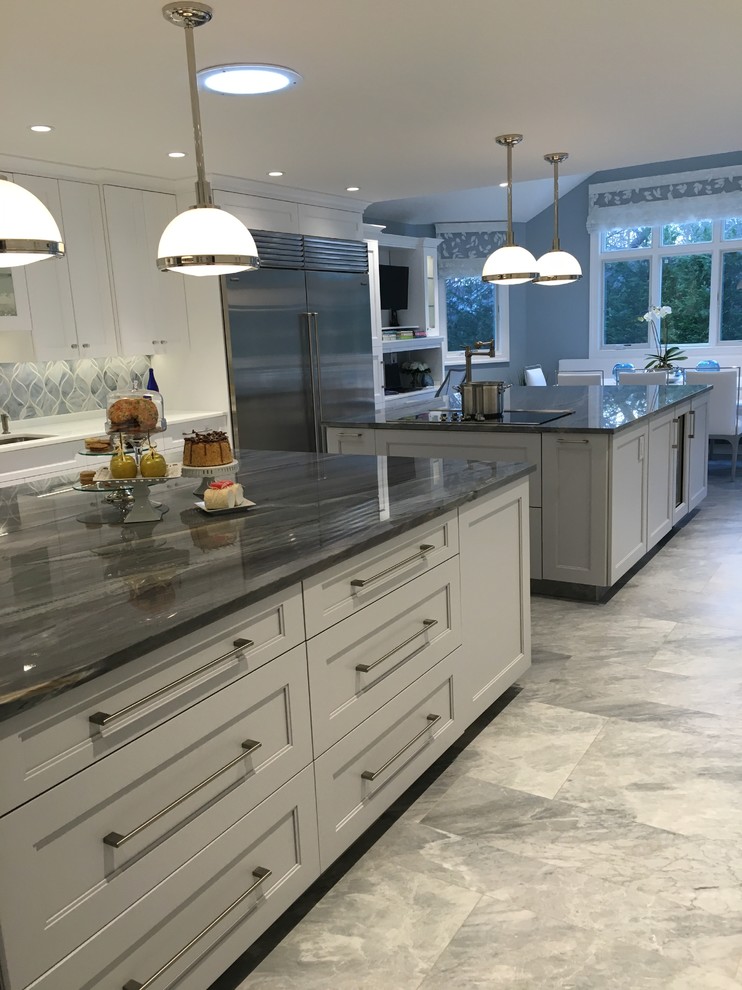 Eat-in kitchen - huge contemporary u-shaped ceramic tile eat-in kitchen idea in New York with a single-bowl sink, shaker cabinets, white cabinets, quartzite countertops, gray backsplash, glass sheet backsplash, stainless steel appliances and two islands