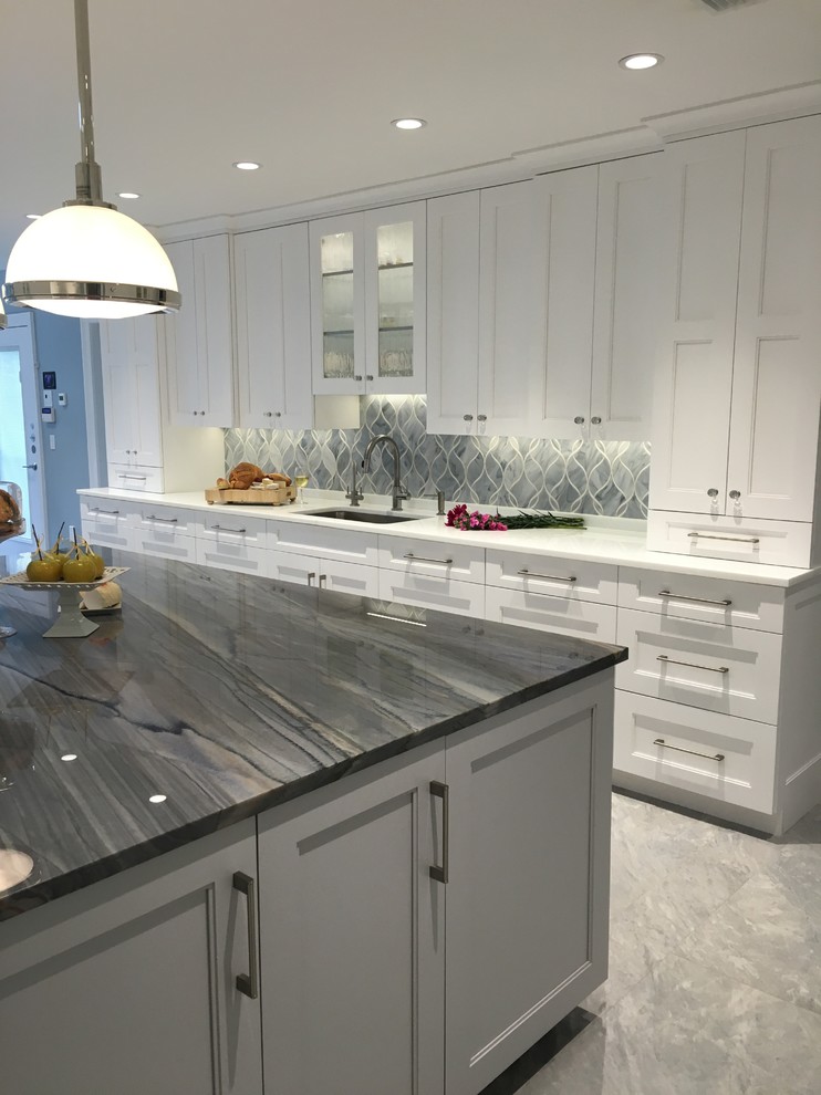Huge trendy u-shaped ceramic tile eat-in kitchen photo in New York with a single-bowl sink, shaker cabinets, white cabinets, quartzite countertops, gray backsplash, glass sheet backsplash, stainless steel appliances and two islands