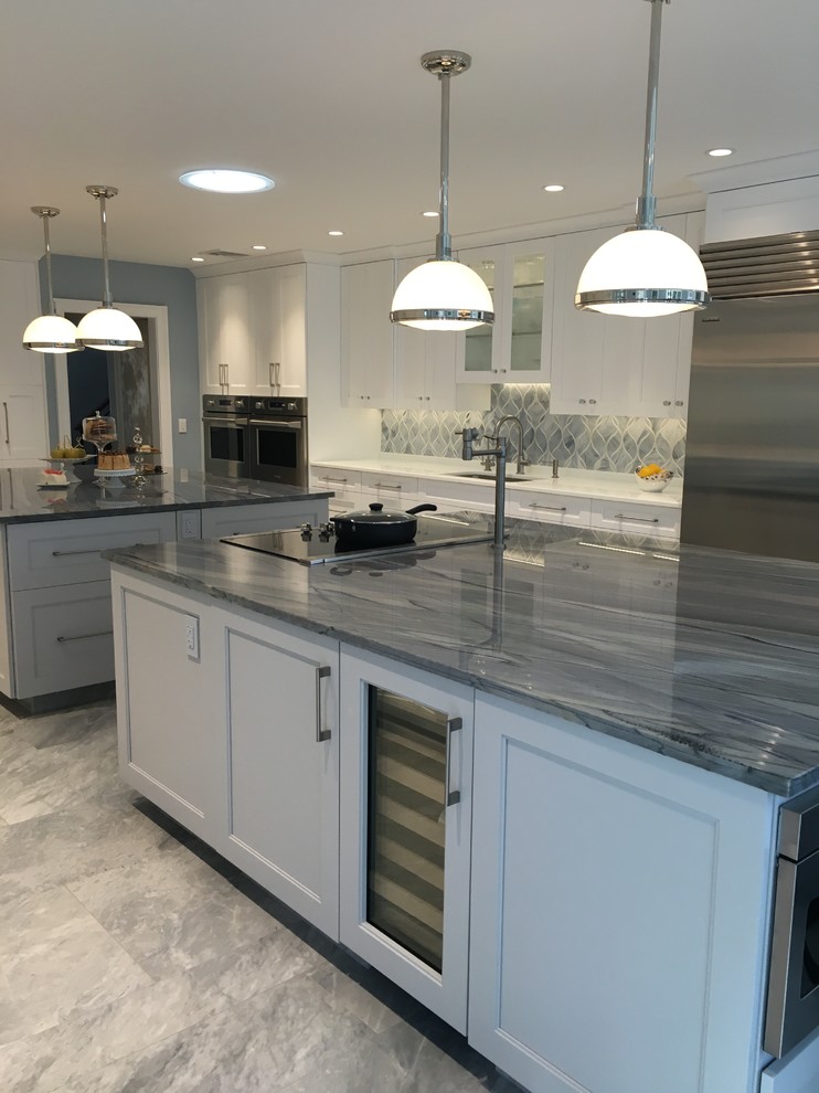 Huge trendy u-shaped ceramic tile eat-in kitchen photo in New York with a single-bowl sink, shaker cabinets, white cabinets, quartzite countertops, gray backsplash, glass sheet backsplash, stainless steel appliances and two islands