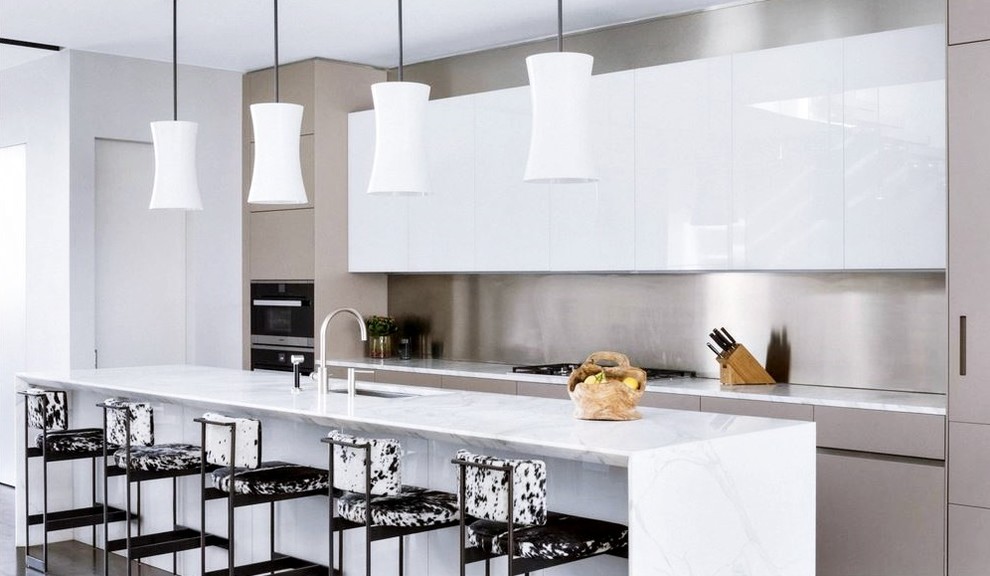 Large minimalist single-wall eat-in kitchen photo in Toronto with an undermount sink, flat-panel cabinets, white cabinets, marble countertops, metallic backsplash, metal backsplash, stainless steel appliances, an island and gray countertops