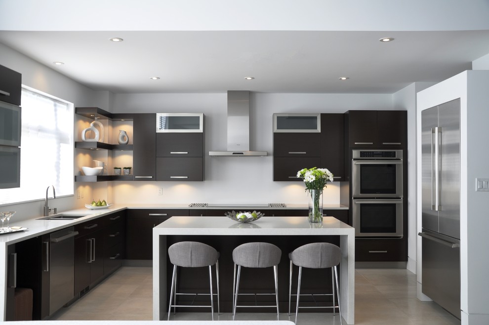 Large modern l-shaped open plan kitchen in Ottawa with a submerged sink, flat-panel cabinets, brown cabinets, quartz worktops, stainless steel appliances, ceramic flooring and an island.