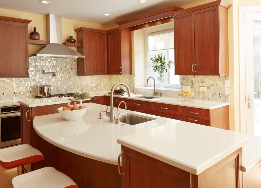 Inspiration for a huge modern l-shaped eat-in kitchen remodel in Chicago with a single-bowl sink, recessed-panel cabinets, medium tone wood cabinets, quartz countertops, white backsplash, glass tile backsplash, stainless steel appliances and an island