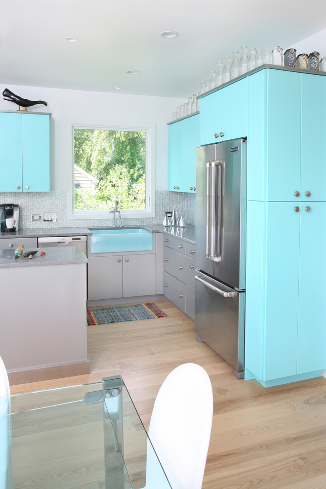 Example of a trendy kitchen design in Boston with stainless steel appliances and a farmhouse sink