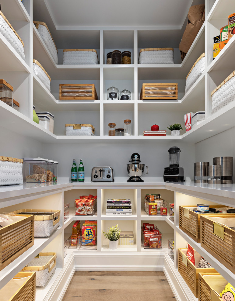 Inspiration for a large modern u-shaped kitchen pantry in Detroit with open cabinets, white cabinets, engineered stone countertops, stainless steel appliances, light hardwood flooring, brown floors, white worktops, no island and feature lighting.