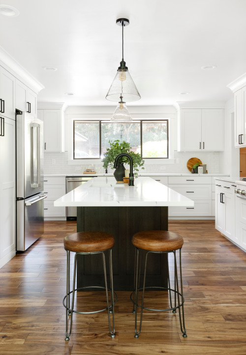 Dark Wood Kitchen Island in a White Kitchen Cabinets with White Cabinets and Marble Countertop