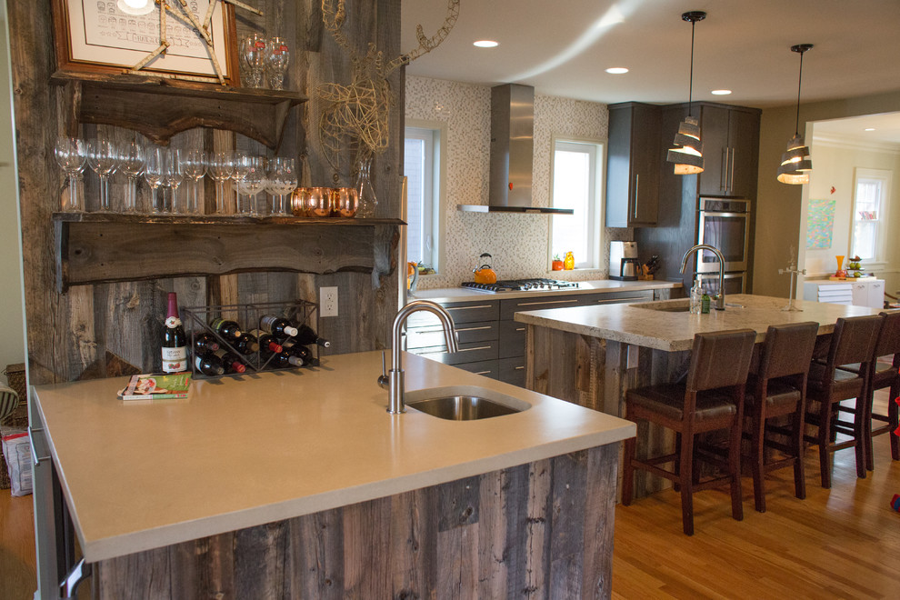 Inspiration for a large rustic u-shaped medium tone wood floor open concept kitchen remodel in St Louis with an undermount sink, flat-panel cabinets, gray cabinets, concrete countertops, stainless steel appliances and an island