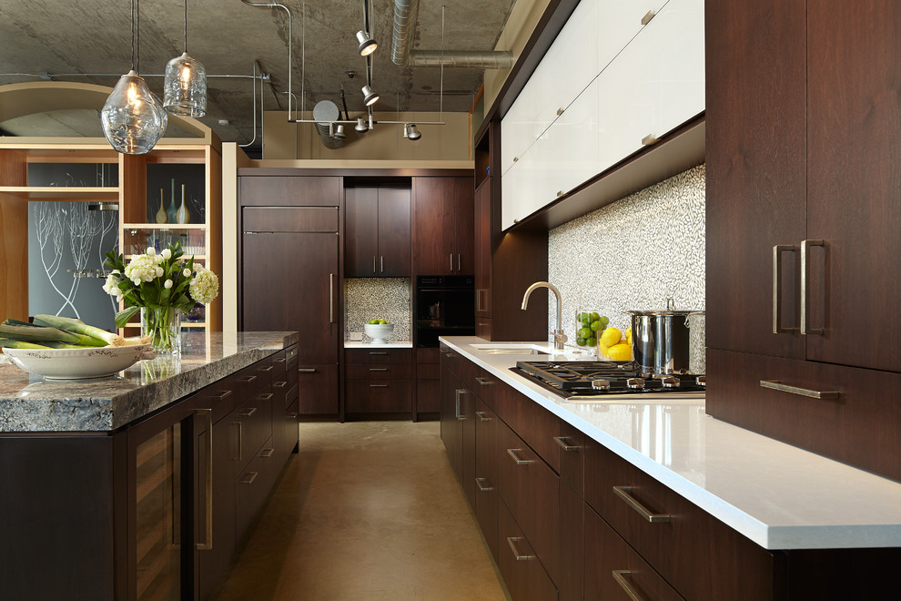 Example of a mid-sized minimalist l-shaped concrete floor open concept kitchen design in Minneapolis with an undermount sink, flat-panel cabinets, dark wood cabinets, granite countertops, white backsplash, glass tile backsplash, paneled appliances and an island