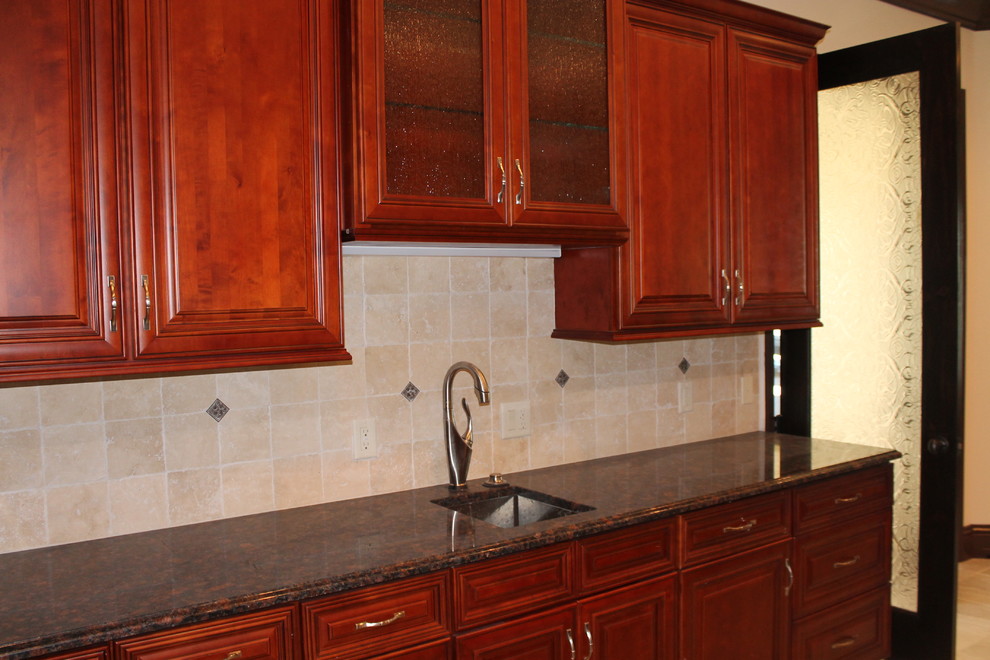 Example of a large classic eat-in kitchen design in Tampa with an undermount sink, glass-front cabinets, red cabinets, granite countertops, beige backsplash, stone tile backsplash, stainless steel appliances and an island