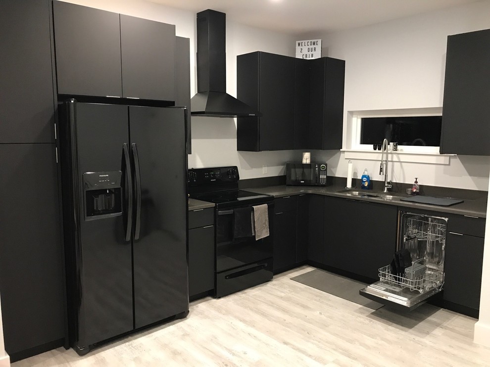 Photo of a small modern u-shaped kitchen/diner in Miami with a submerged sink, flat-panel cabinets, black cabinets, quartz worktops, grey splashback, integrated appliances, light hardwood flooring, no island and white floors.