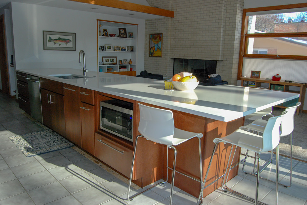 Photo of a medium sized modern single-wall kitchen/diner in Other with a submerged sink, flat-panel cabinets, medium wood cabinets, engineered stone countertops, white splashback, ceramic splashback, stainless steel appliances, an island and white worktops.