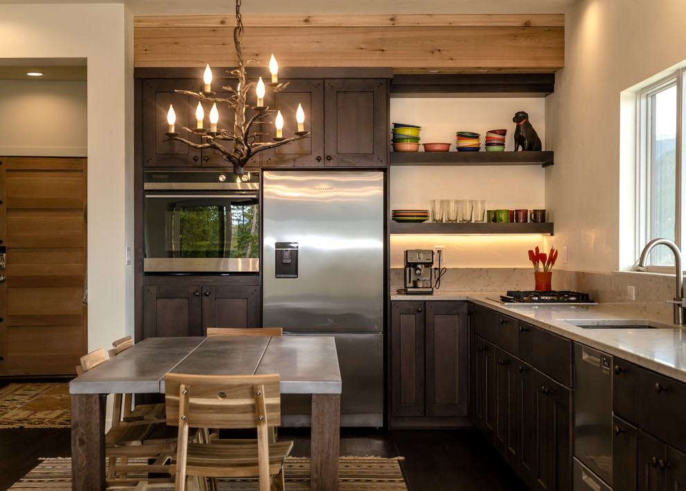 Eat-in kitchen - mid-sized modern l-shaped laminate floor and brown floor eat-in kitchen idea in Denver with an undermount sink, shaker cabinets, dark wood cabinets, quartz countertops, white backsplash, stainless steel appliances, an island and white countertops