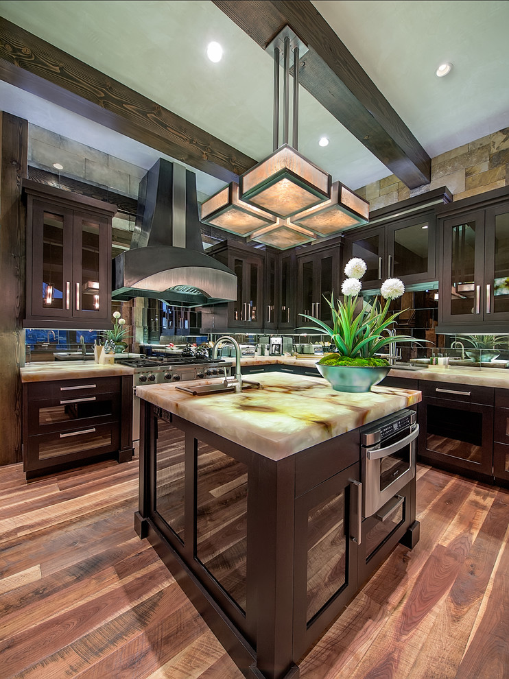 Example of a huge trendy l-shaped medium tone wood floor kitchen design in Denver with an undermount sink, dark wood cabinets, mirror backsplash and two islands