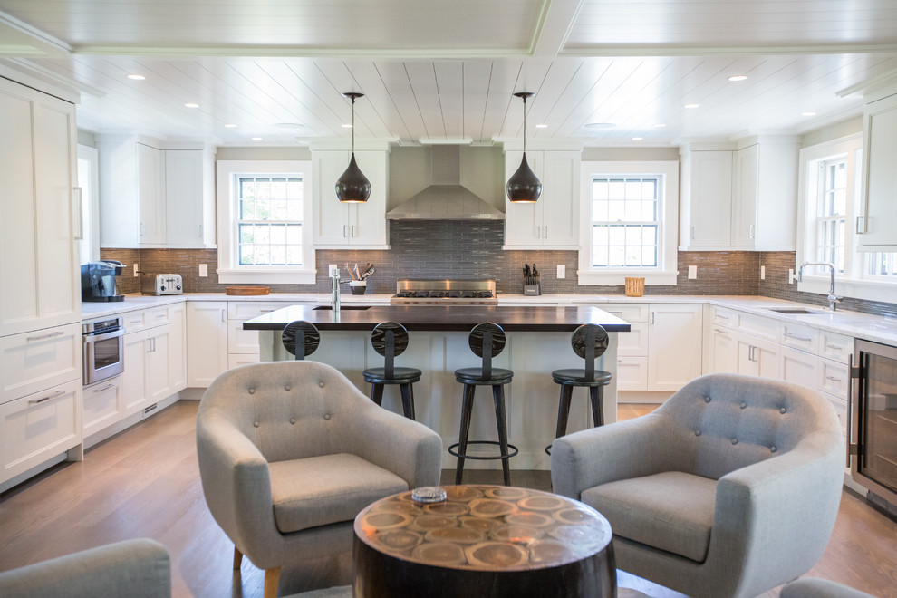 Open concept kitchen - contemporary u-shaped open concept kitchen idea in Boston with shaker cabinets, white cabinets, gray backsplash and paneled appliances