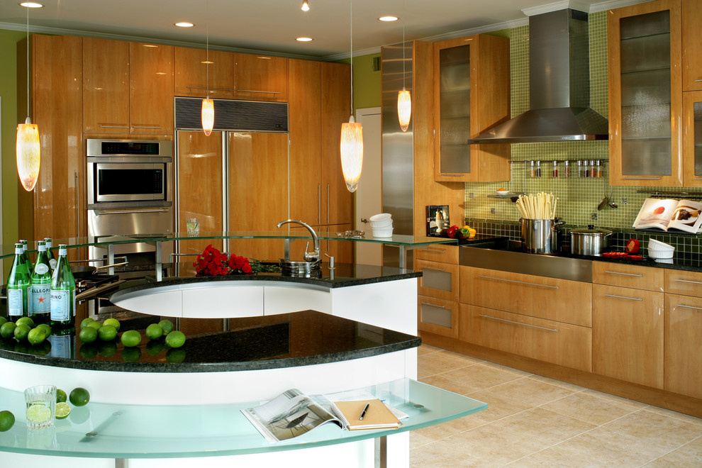 Example of a large minimalist porcelain tile eat-in kitchen design in New York with green backsplash, glass tile backsplash, an undermount sink, flat-panel cabinets, light wood cabinets, glass countertops, stainless steel appliances and an island